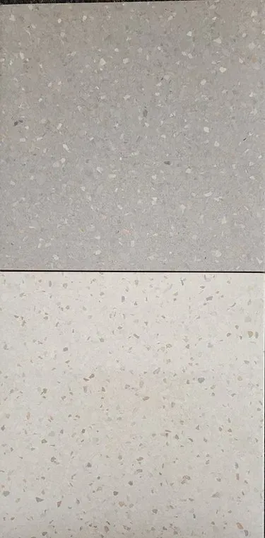 Two speckled wall or tile surfaces, one gray and one off-white, separated by a horizontal line.