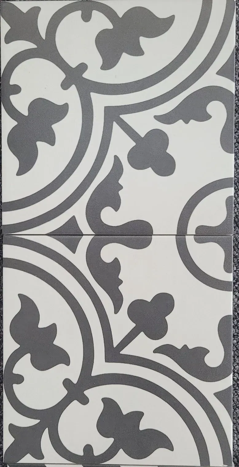 Gray-and-white decorative tile pattern with curved floral motifs and repeating geometric borders