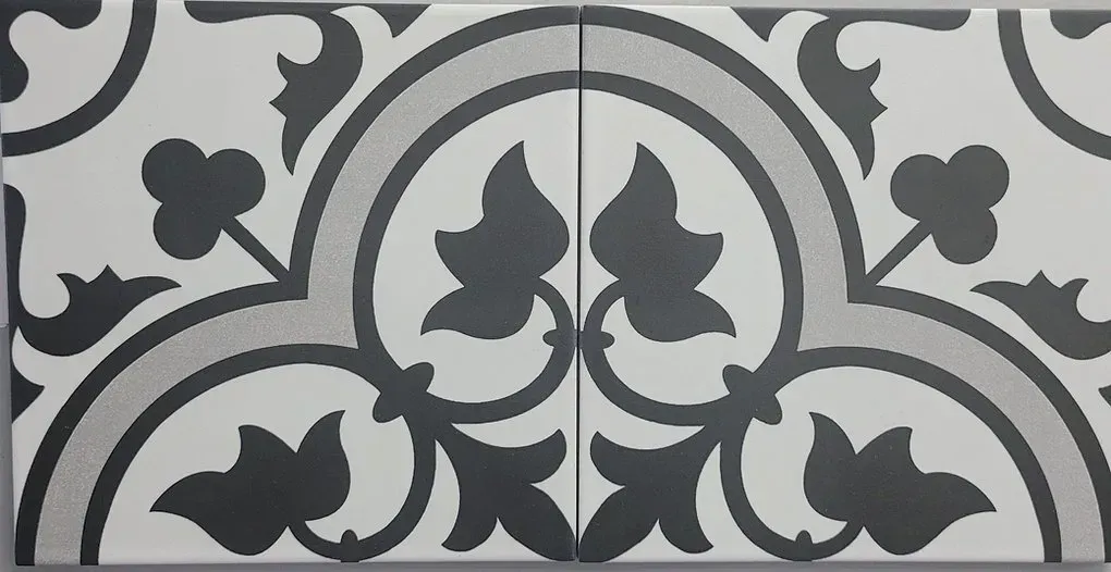 Black-and-white decorative tile pattern with symmetrical floral and geometric motifs