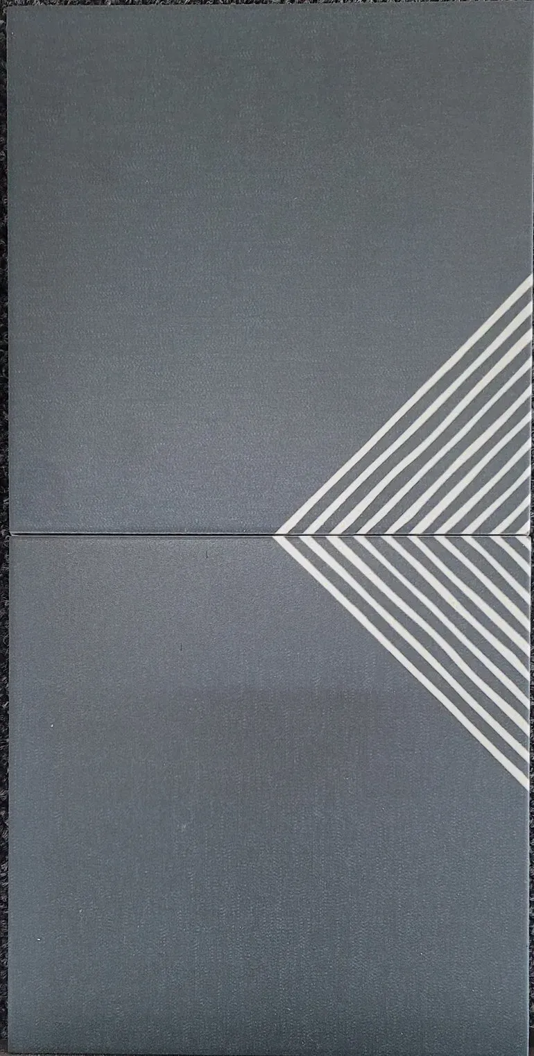 Gray textured surface with white chevron stripes pointing inward from the right side