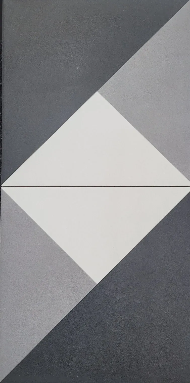 Geometric gray pattern with a white diamond shape centered on a dark gray background