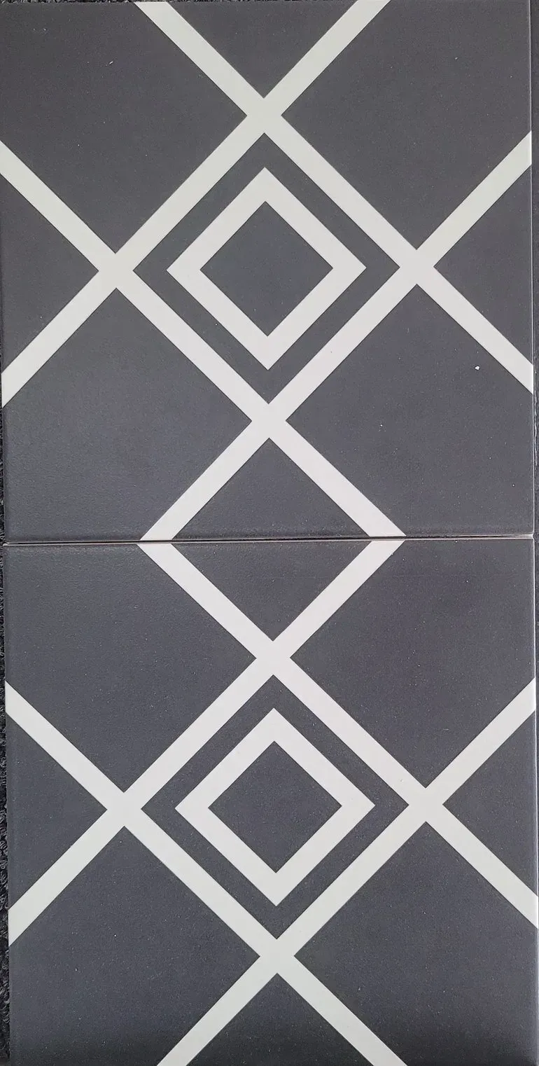 Gray wall tiles with white diamond lattice patterns, split by a horizontal seam.