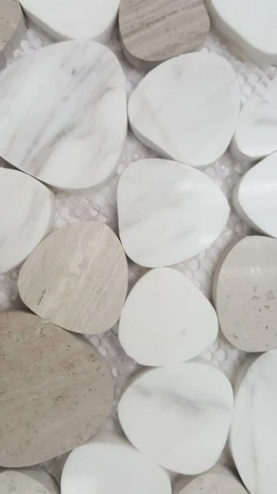 White and beige round tile pieces arranged in a close-up pattern