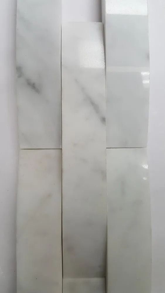 Three vertical white marble tiles with light gray veining