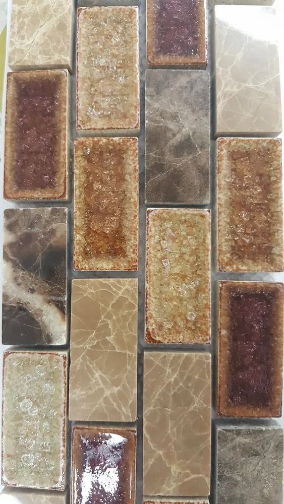 Multicolored decorative mosaic tile pattern with brown, gray, and beige rectangular tiles