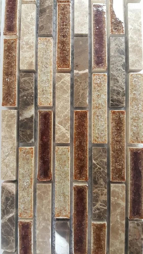 Vertical mosaic tile wall with narrow beige, gray, and rust-colored glass rectangles