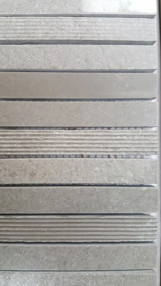 Gray metal panel with horizontal ridges and textured sections