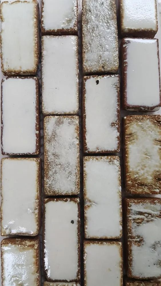 Close-up of light gray and tan brick paving with weathered grout lines
