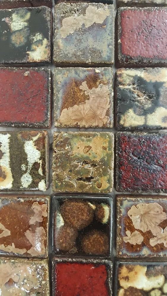 Close-up of weathered multicolored stone tiles in a grid pattern