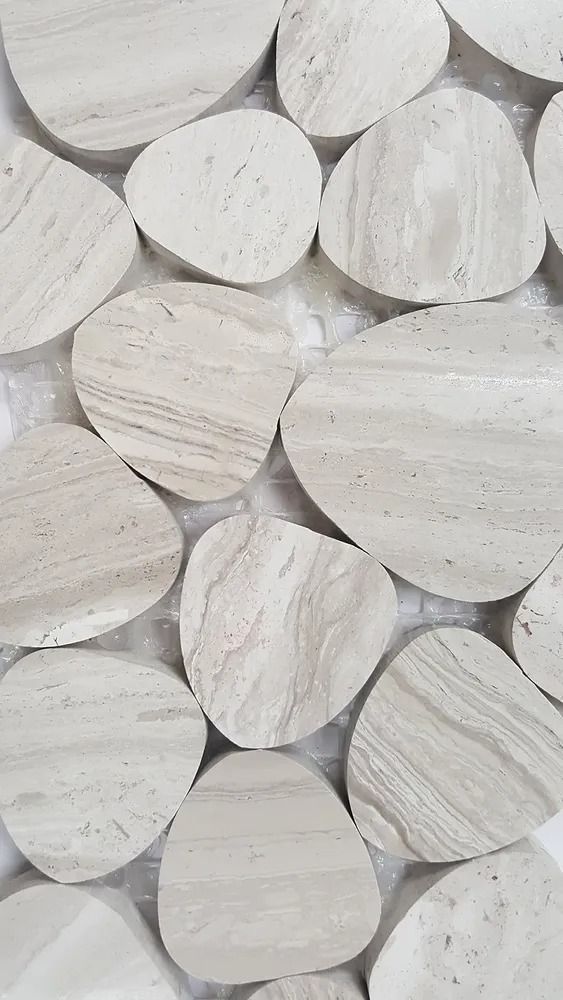 Close-up of stacked white wooden discs with visible grain patterns