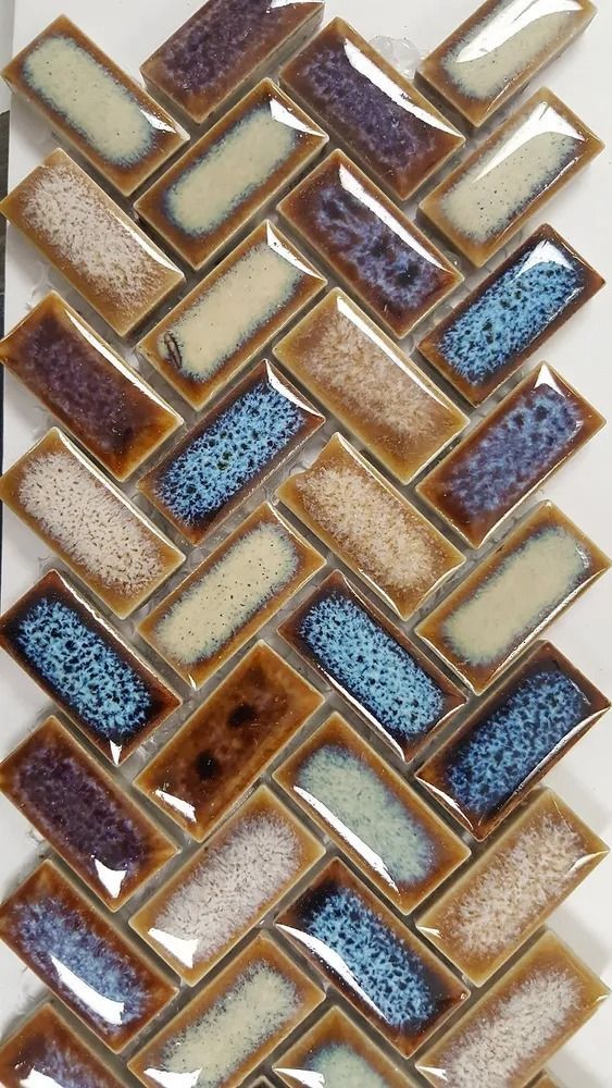 Abstract mosaic of interlocking diamond tiles in beige, brown, and blue tones