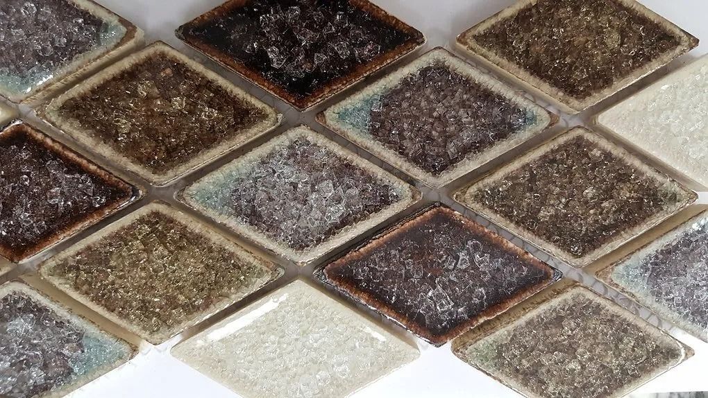Close-up of diamond-shaped mosaic tiles in brown, gray, and beige tones.