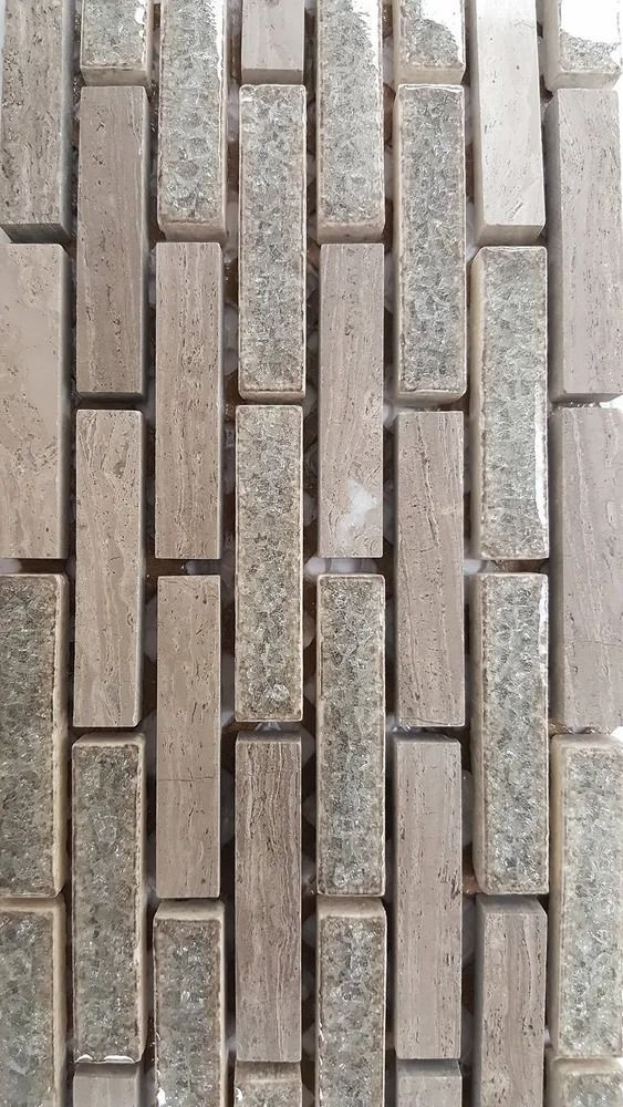 Vertical gray and beige brick or tile pattern with narrow rectangular blocks