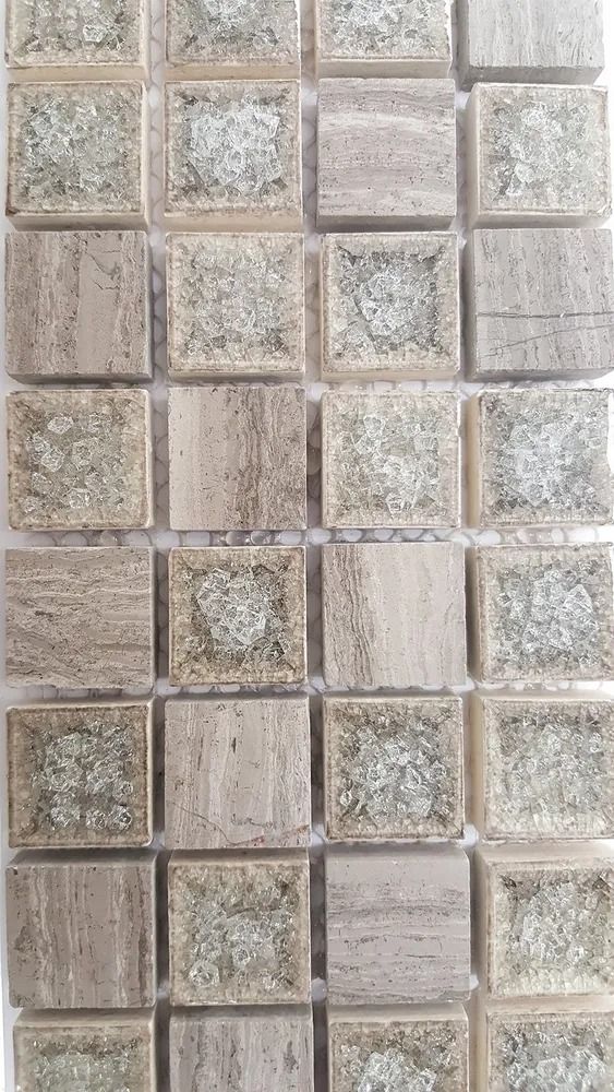 Close-up of a beige and gray textured tiled wall with a grid pattern