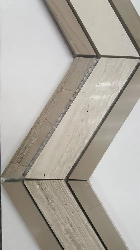 Close-up of a zigzag decorative wall trim in beige and white panels