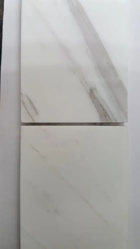 Two white marble-look tile samples, one above the other, with gray veining.