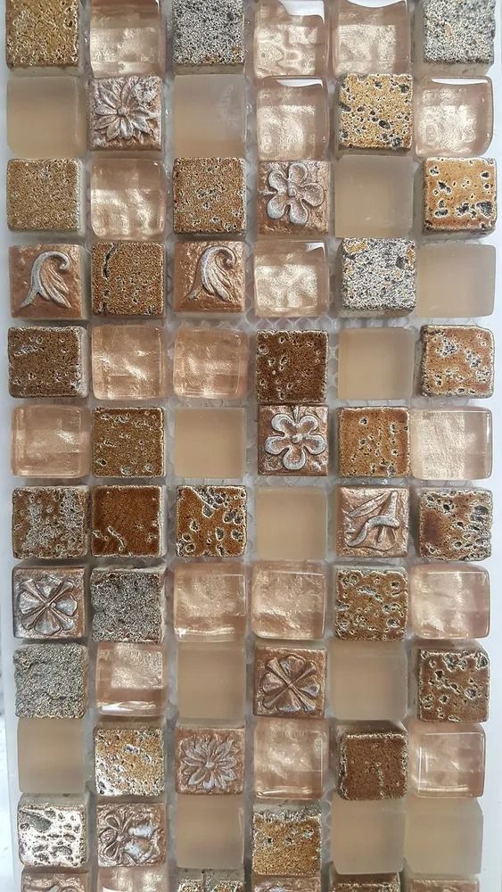 Mosaic of small square glass tiles in beige, brown, and white tones, arranged in a grid.