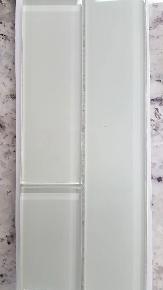 Two white rectangular wall panels or cabinet doors on a light patterned surface