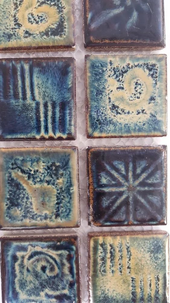 Close-up of blue and tan decorative ceramic tiles with varied embossed patterns