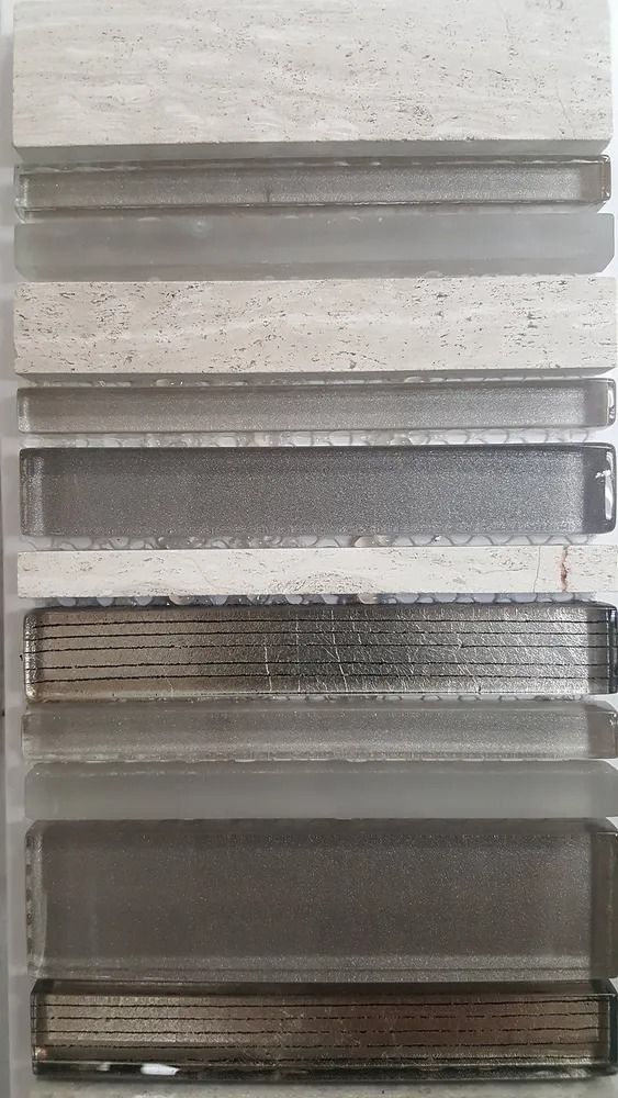 Stacked gray translucent plastic panels against a light wall, shown vertically in a close-up.
