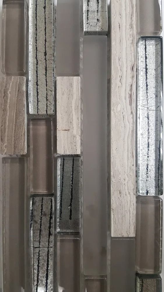 Abstract mosaic of vertical rectangular tiles in gray, beige, and silver tones