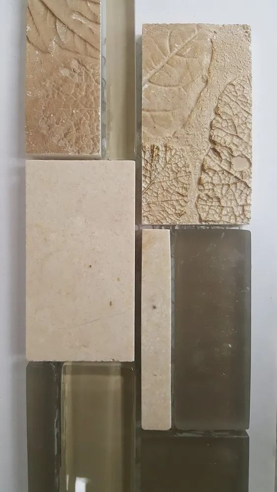 Assorted beige and brown textured tile samples arranged in a vertical display.