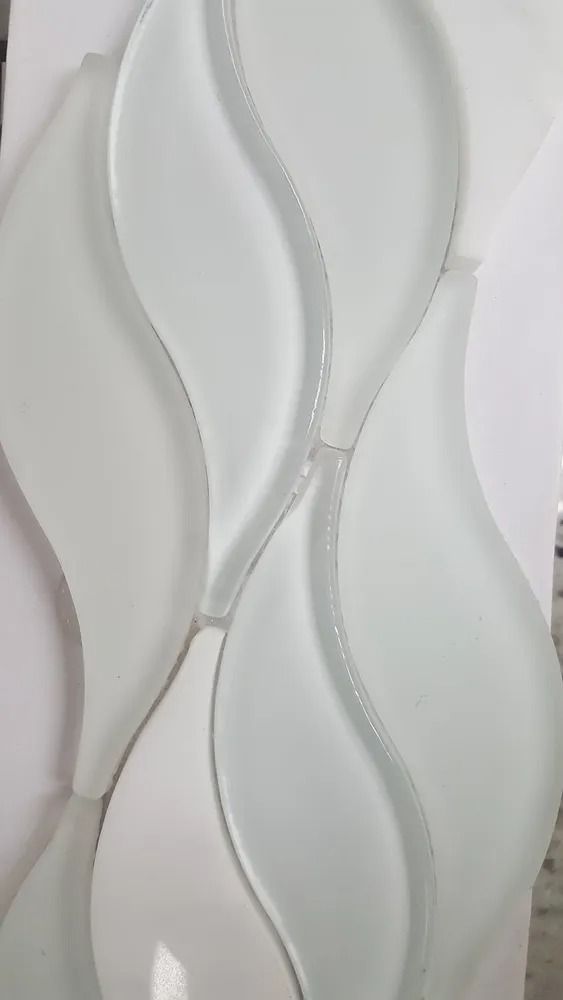 White decorative wall panel with wavy textured 3D design and silver trim lines