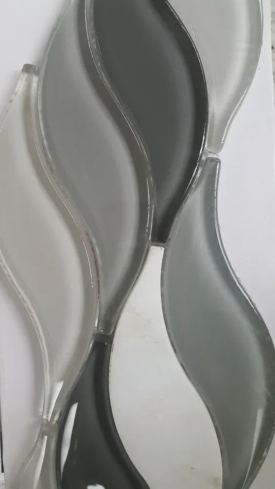 Abstract silver and gray wavy glass or ceramic wall decor with layered curved panels