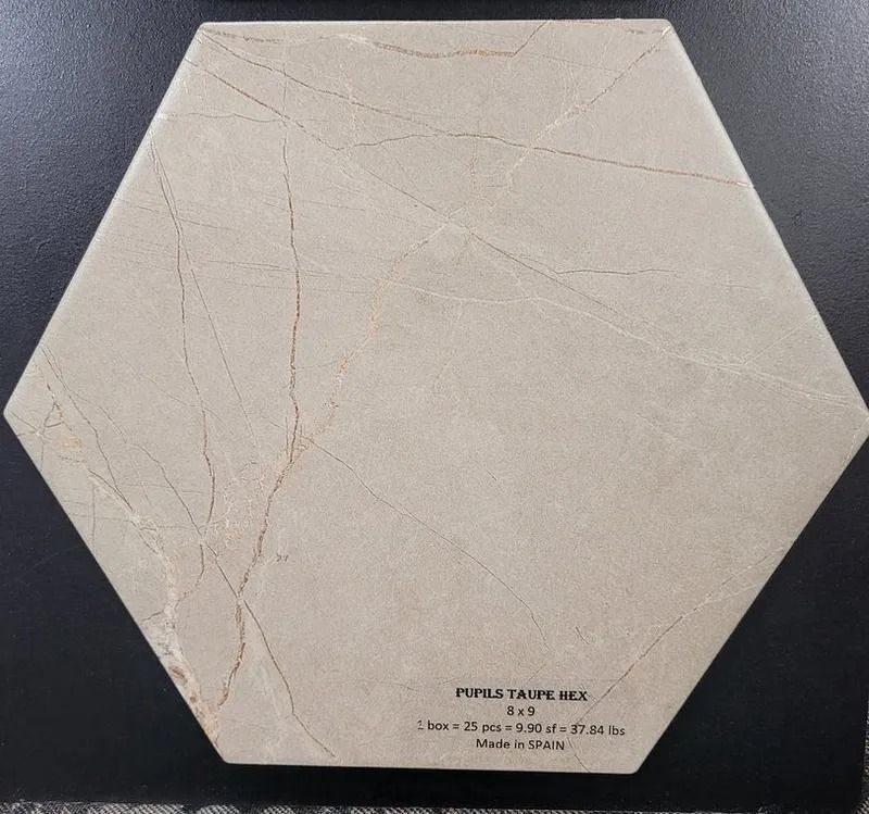 Hexagonal beige label with faint crack lines and small text on a dark background