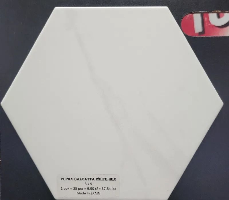 White hexagonal tile sample on dark background with small printed label at bottom
