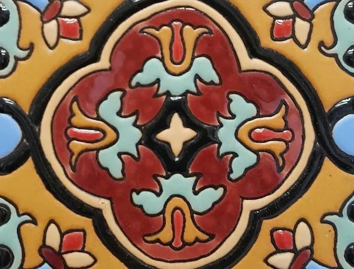 Colorful floral tile pattern with red, teal, yellow, and black ornamental designs