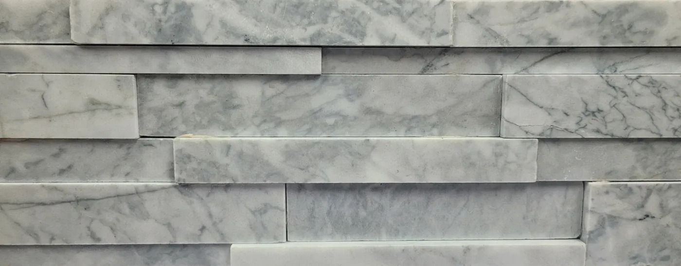 Gray stacked stone wall with a textured, layered surface