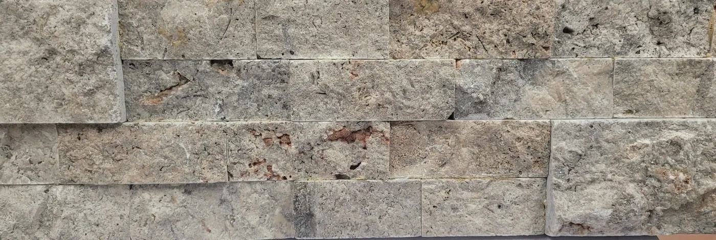 Close-up of a gray and tan stacked stone wall texture