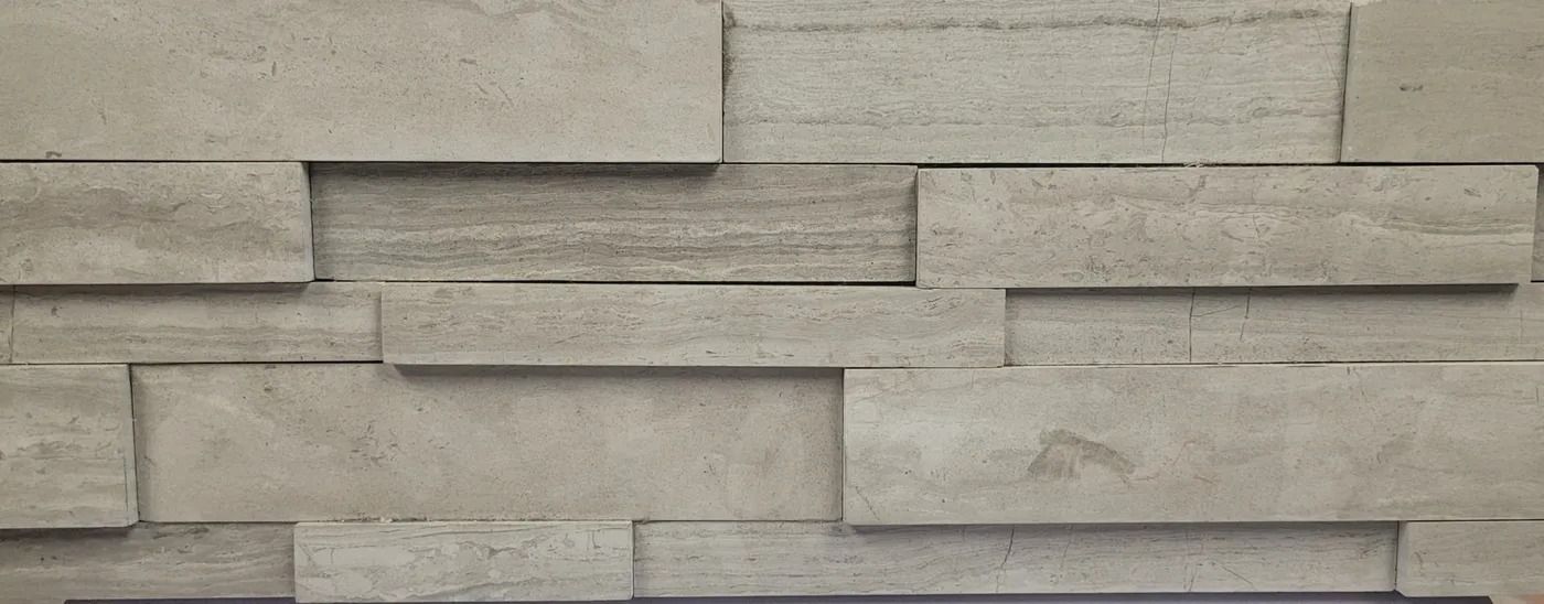 Gray stacked stone wall with horizontal rectangular blocks