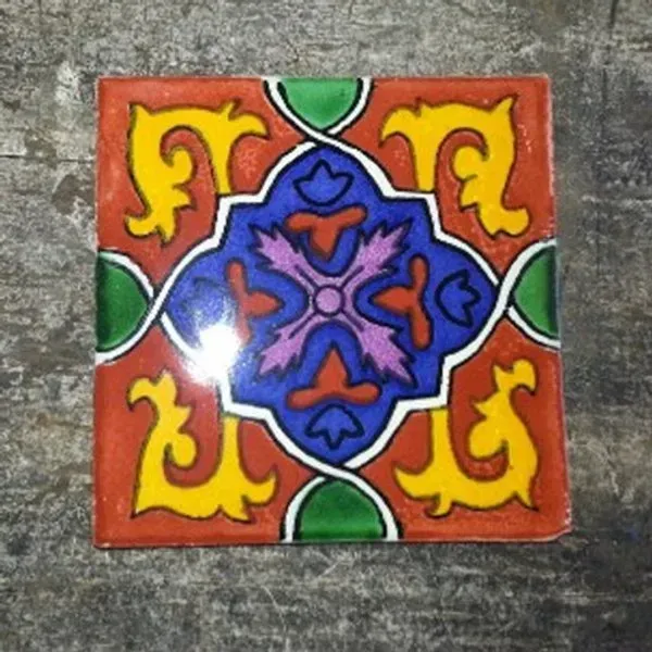 Colorful square tile with red, blue, yellow, and green floral geometric pattern