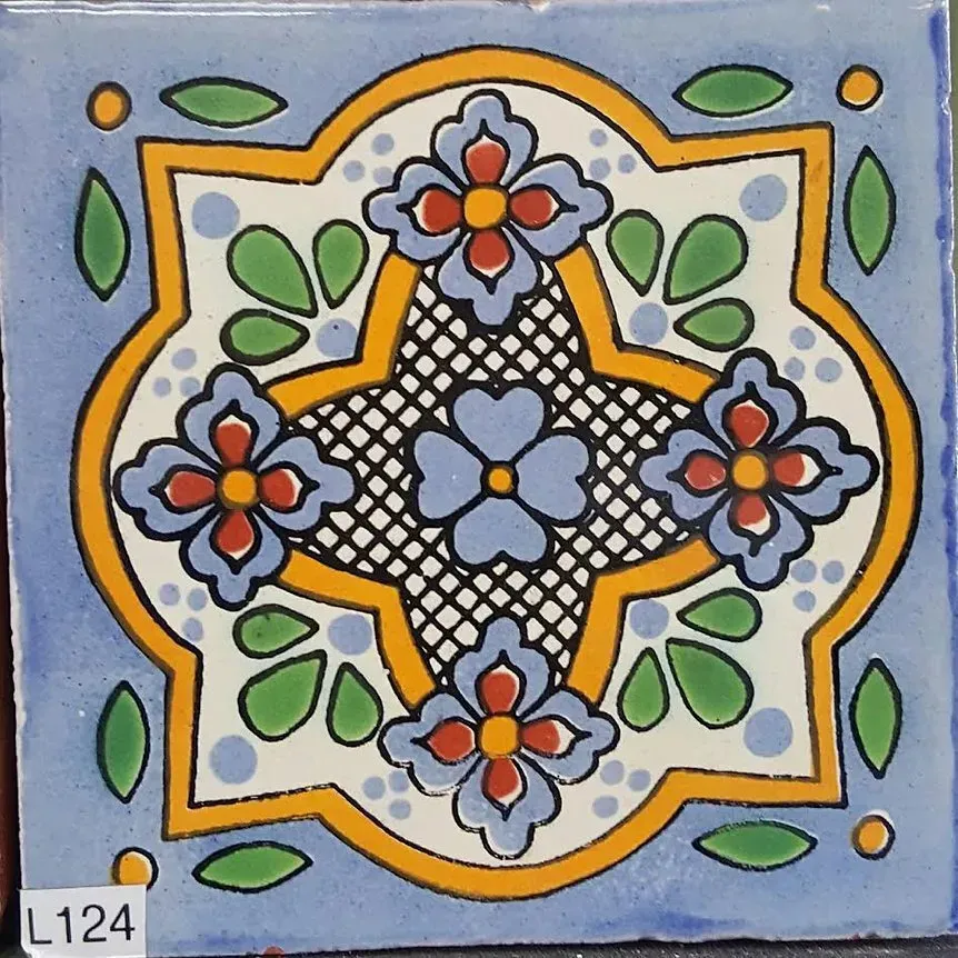 Decorative blue tile with orange, green, and red floral pattern and black lattice center.