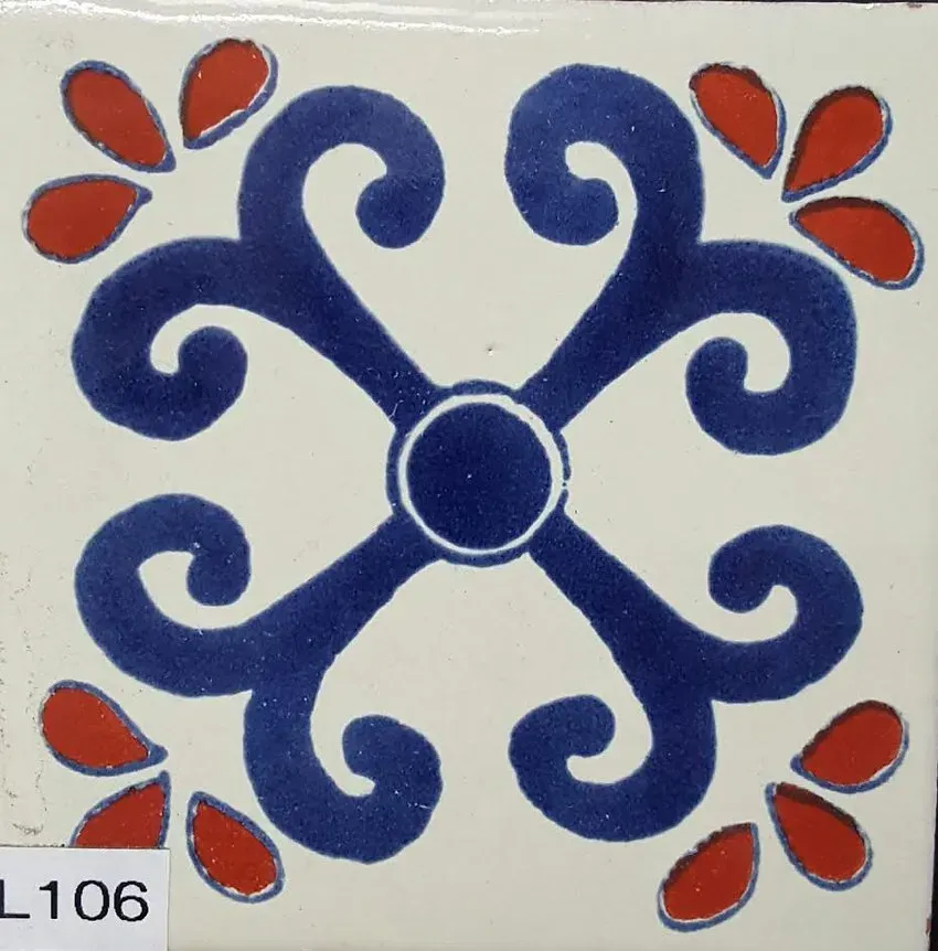Blue ornamental tile with red floral accents around a central circle