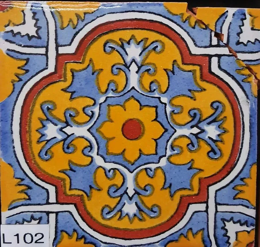 Colorful geometric tile with red, blue, yellow, and white floral pattern, labeled L102