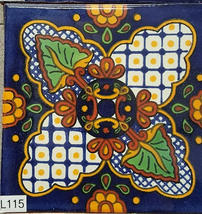 Colorful floral tile with blue background, white patterned corners, and orange-green central ornamentation