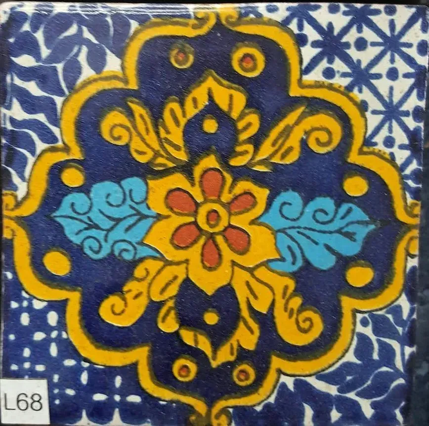 Blue and yellow floral tile pattern with a red flower center and white patterned corners