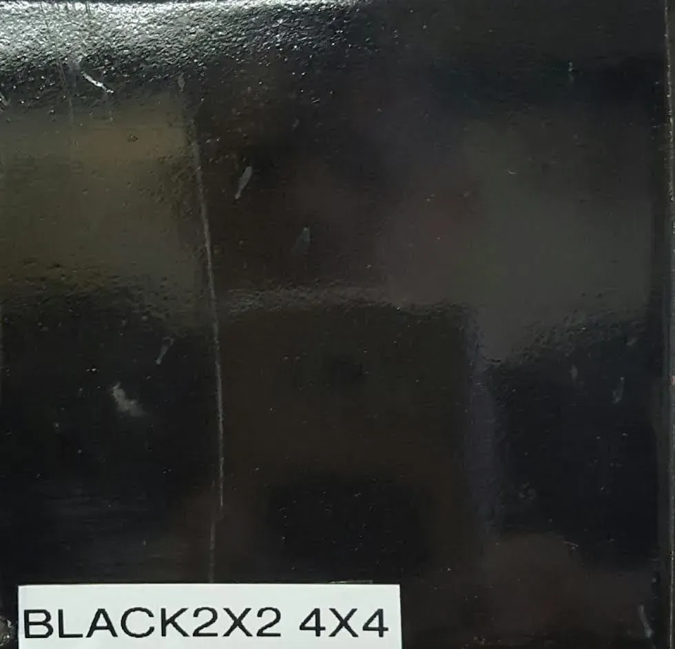 Black glossy surface with a white label reading “BLACK2X2 4X4”