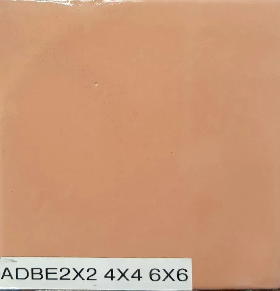 Plain peach-colored tile with a small label reading