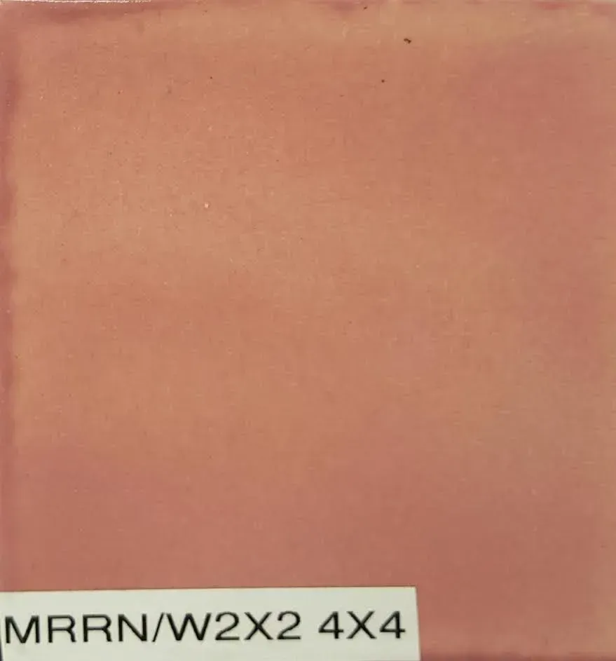 Close-up of a peach-colored surface with a small label reading “MRRN/W2X2 4X4” at the bottom.