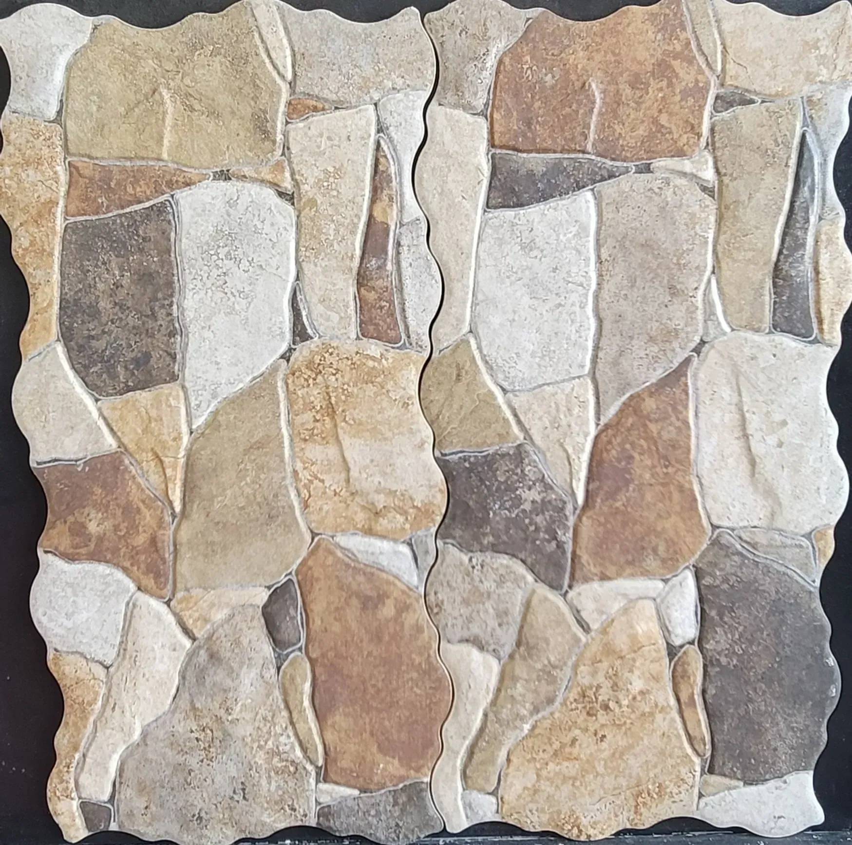 Patchwork stone wall with beige, tan, gray, and white irregular stones