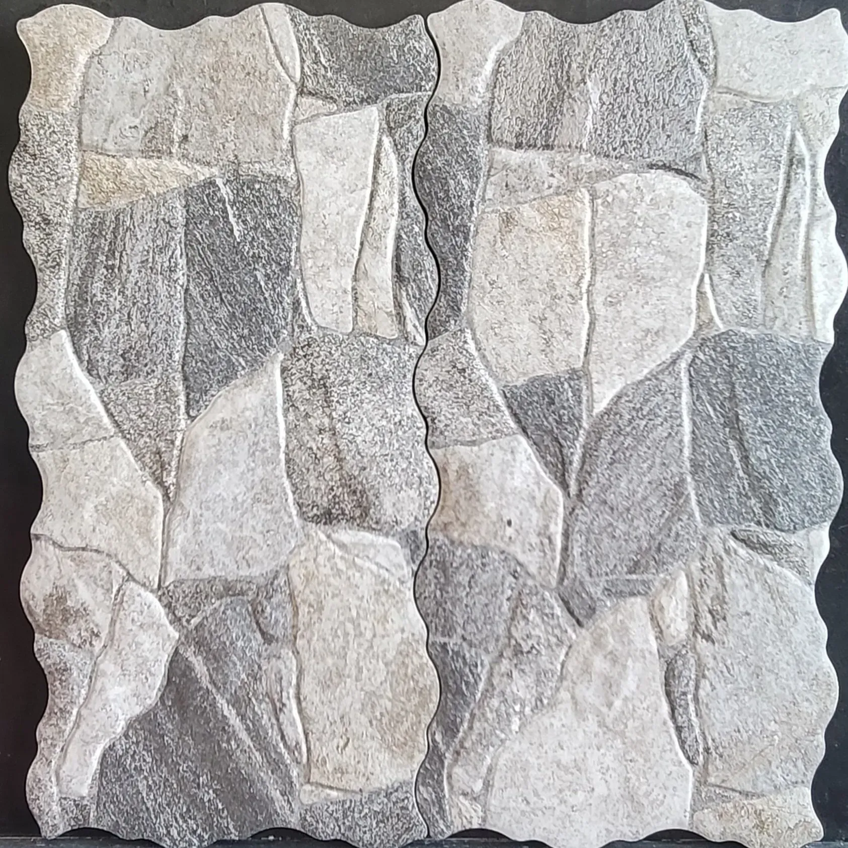 Close-up of a gray and white textured stone tile wall pattern