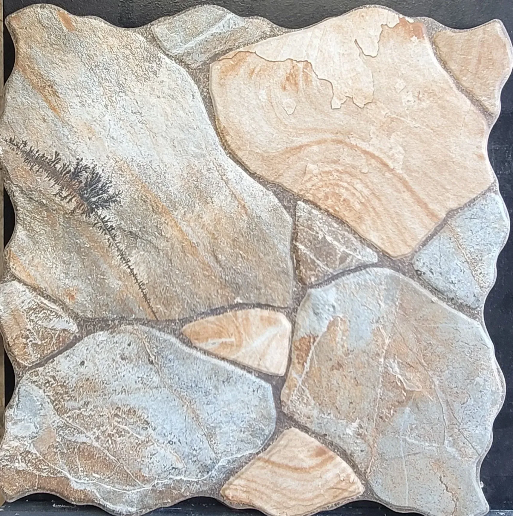 Close-up of tan and gray irregular stone tiles arranged in a mosaic pattern
