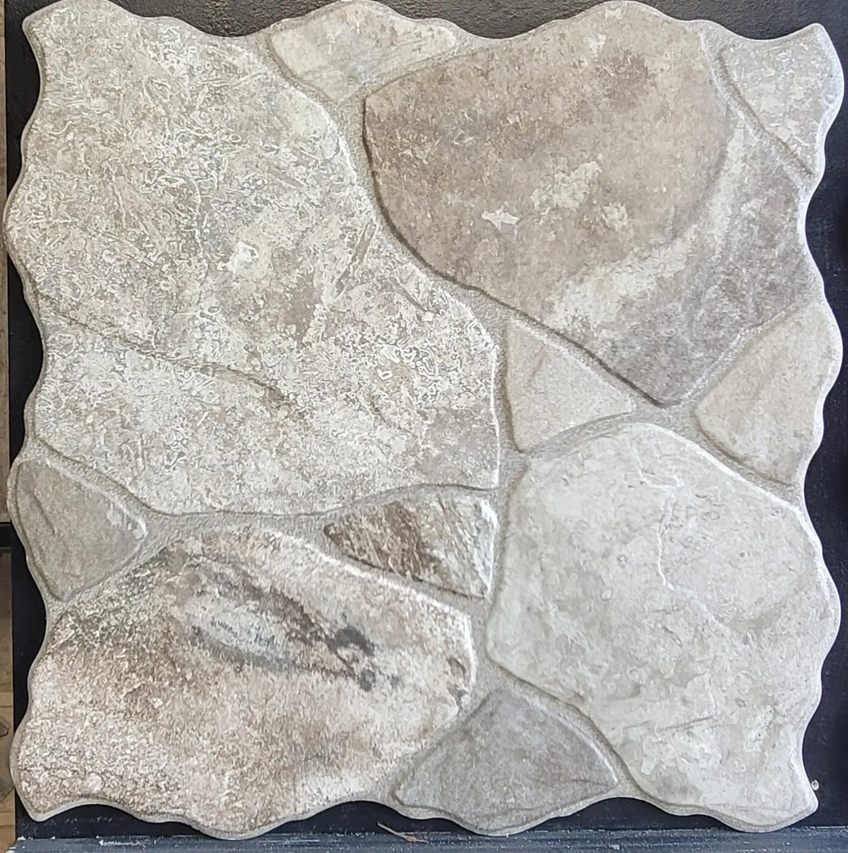 Square light gray stone tile with irregular mosaic pattern and subtle beige veins
