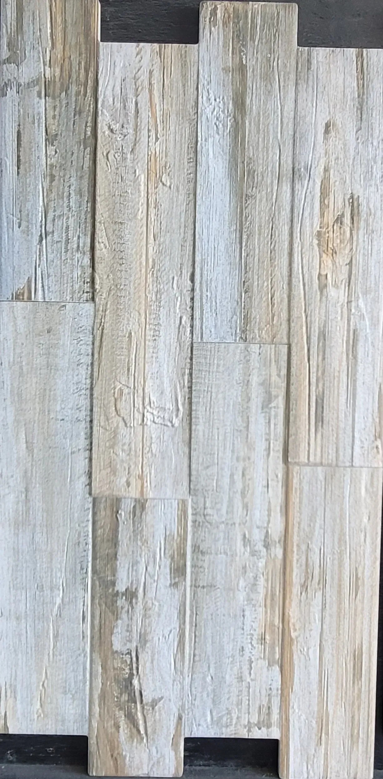 Weathered gray wood planks with whitewashed vertical boards and darker gaps between them
