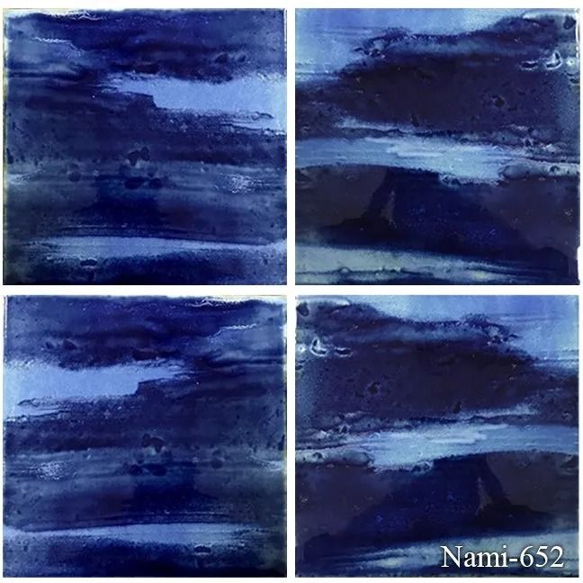 Four blue abstract watercolor panels arranged in a 2x2 grid with a small signature in the corner