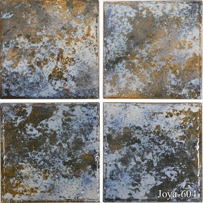 Four weathered square tiles with mottled gray, brown, and white patina, arranged in a 2x2 grid.